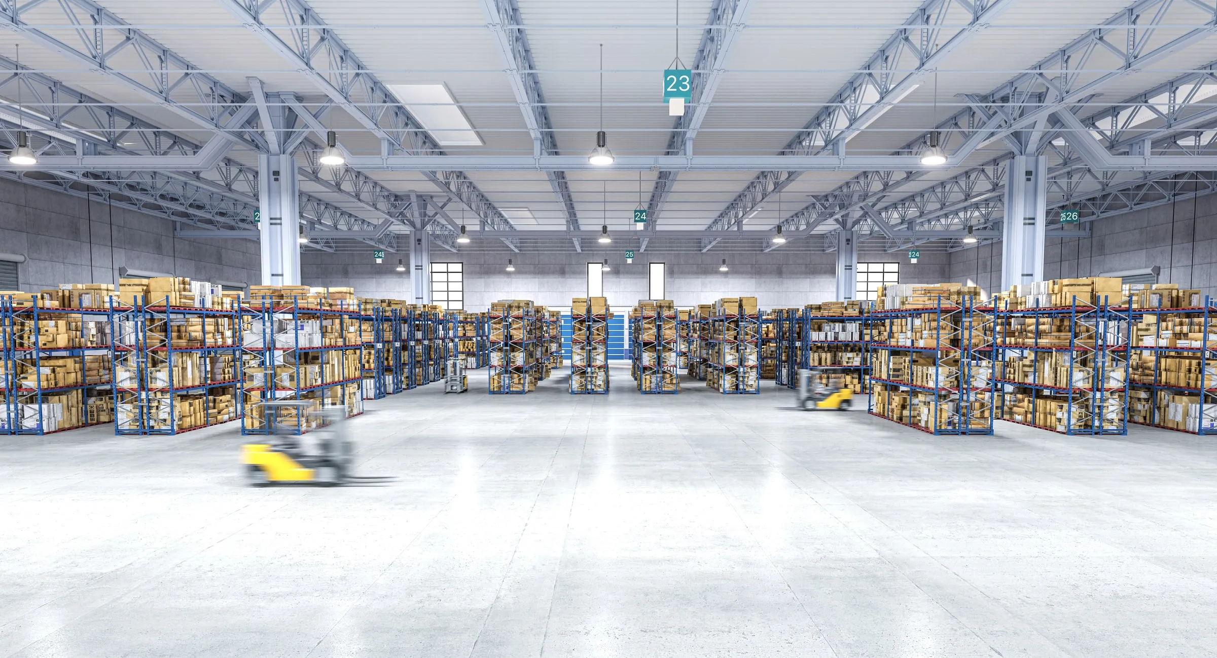 Wide warehouse interior with tall racking on both sides and a forklift in the aisle