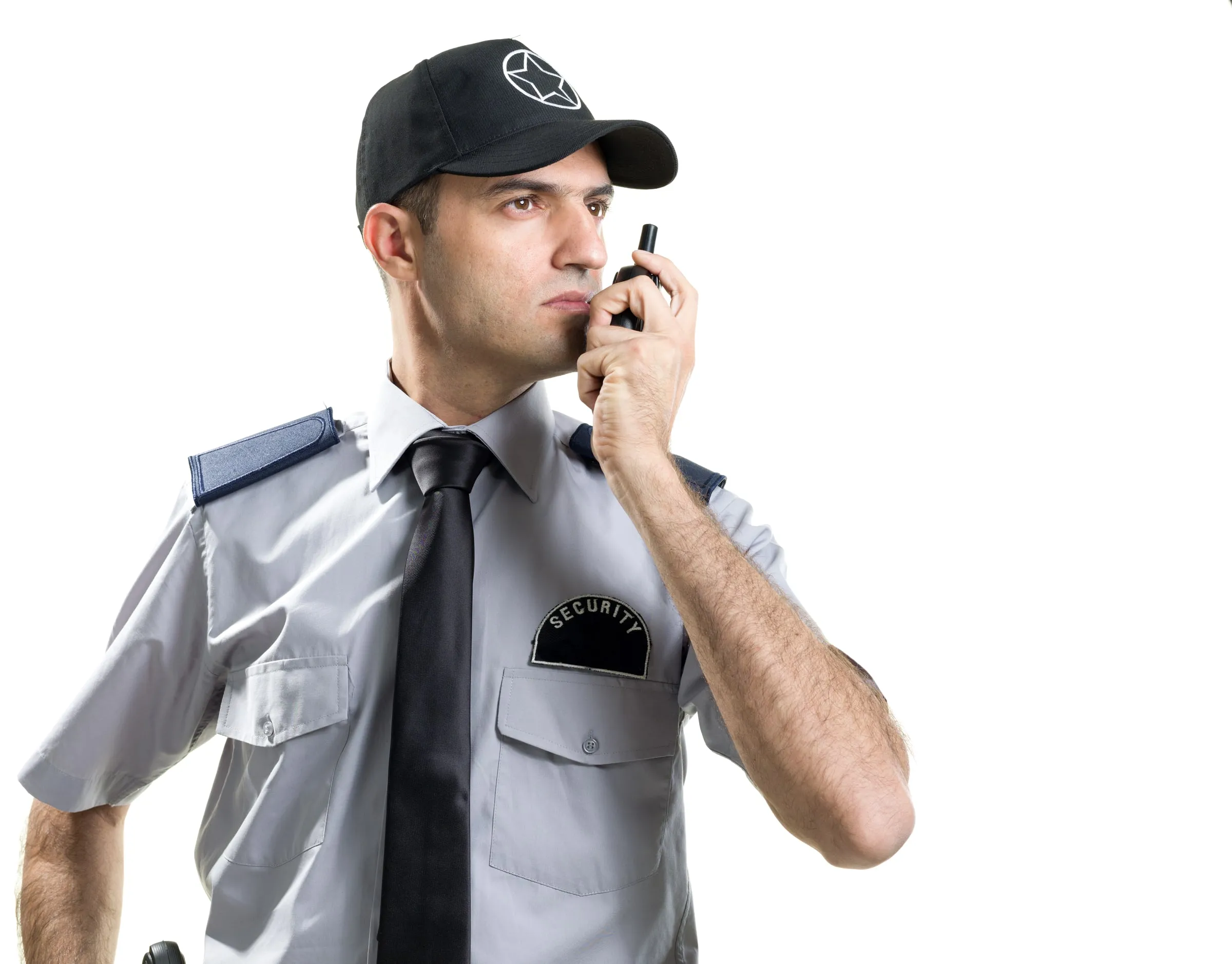 Security officer in a grey uniform and cap speaking into a handheld radio