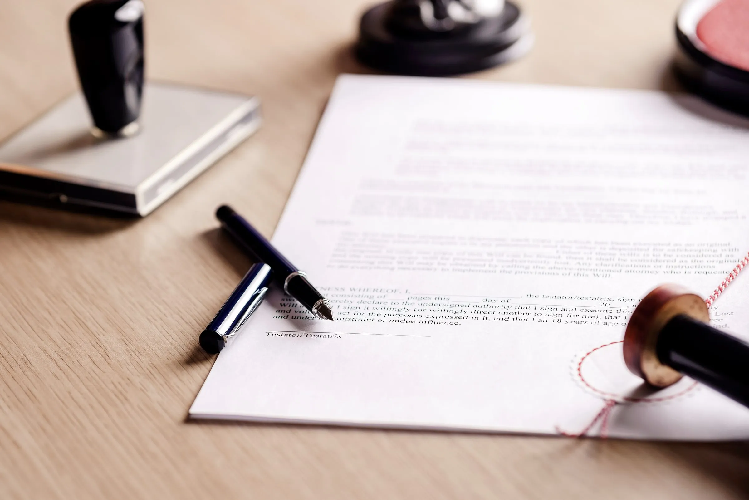 Fountain pen resting on a printed document on a desk