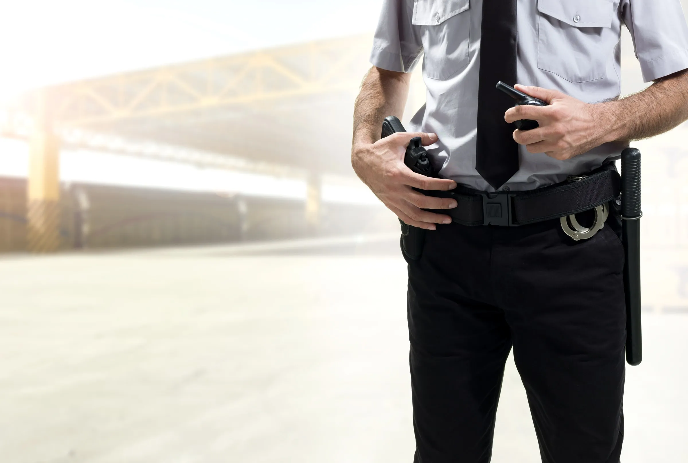 Security officer's duty belt with a baton and radio holster, seen from the side