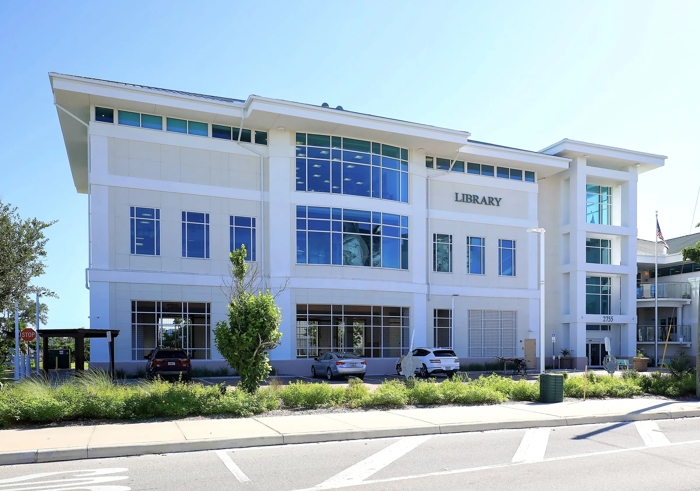 Modern two-story public library with a glass entrance and LIBRARY lettering