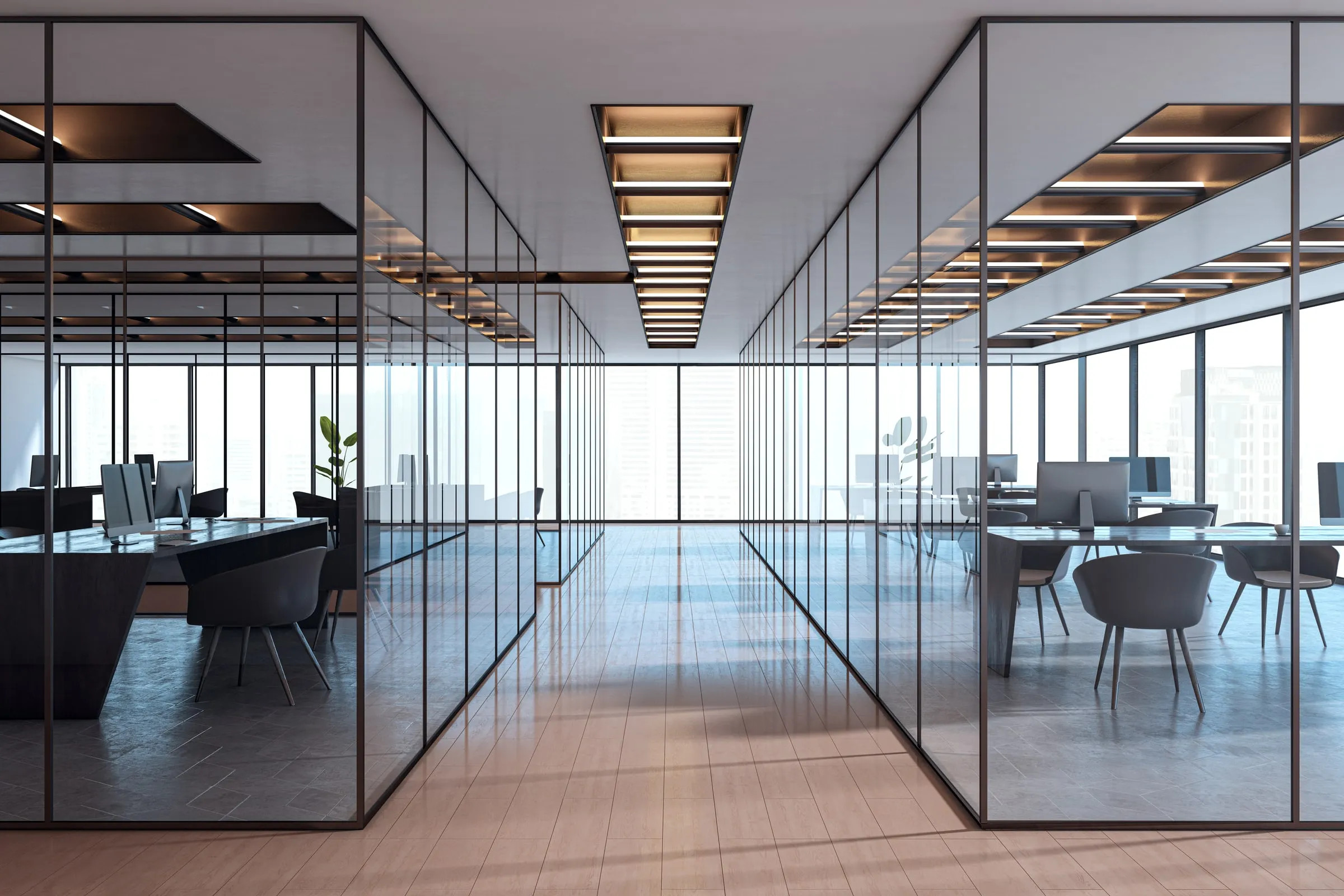 Empty modern office with glass partitions and rows of desks