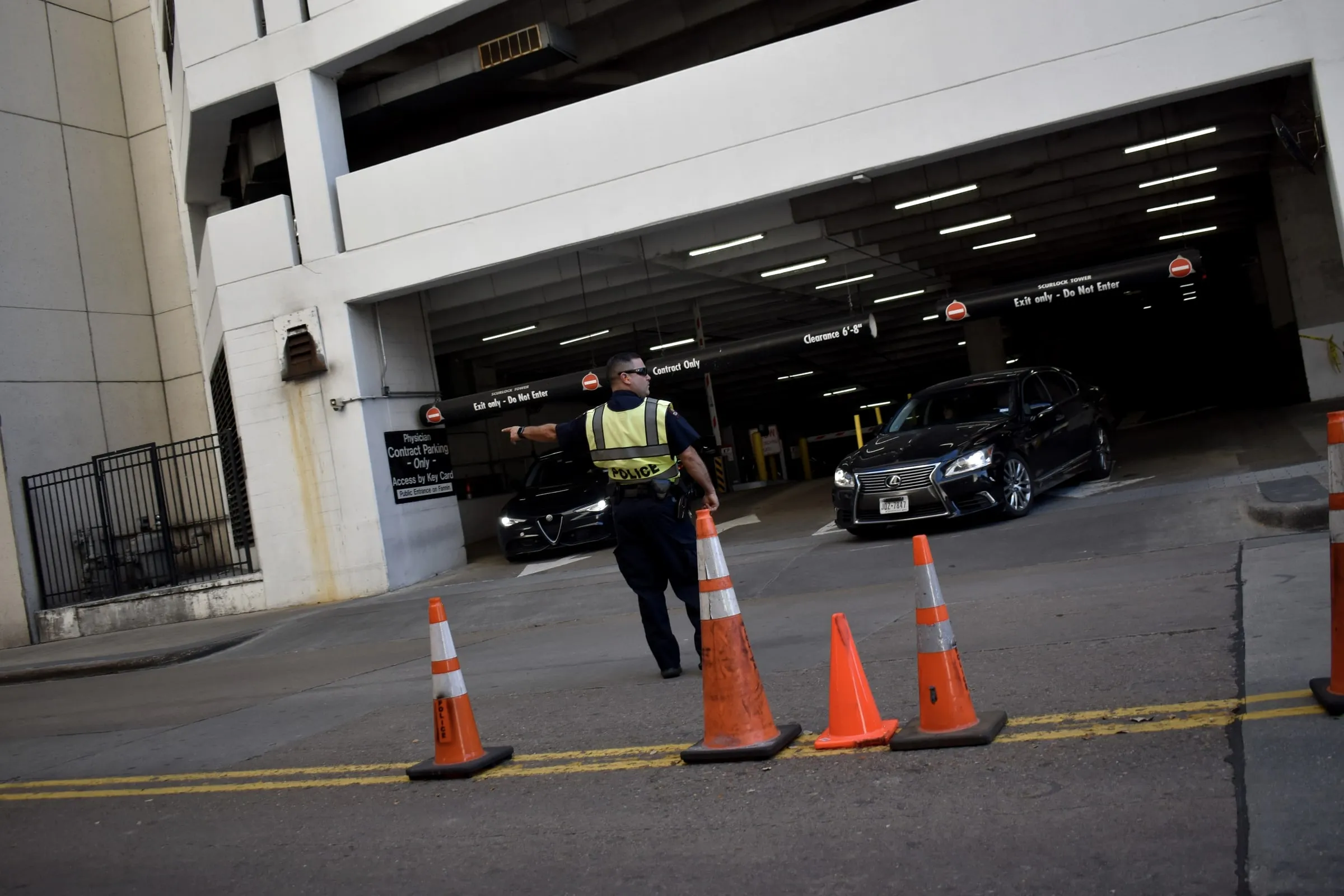 Security officer directing traffic at a hospital parking structure