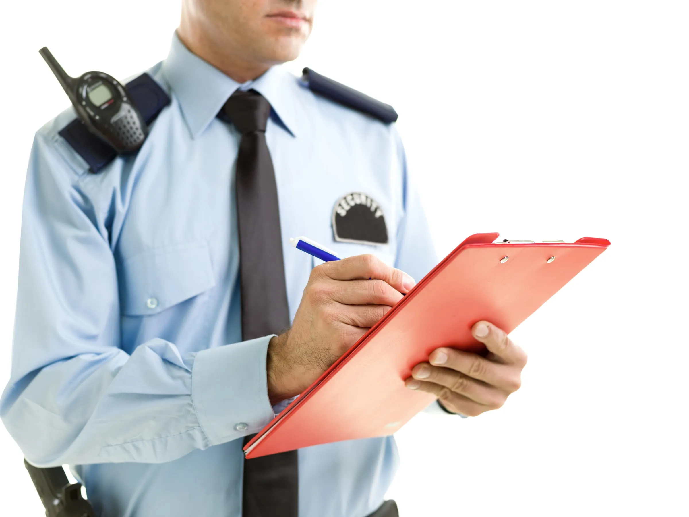 Security officer in a light blue uniform shirt and tie with a shoulder radio, writing on a red clipboard