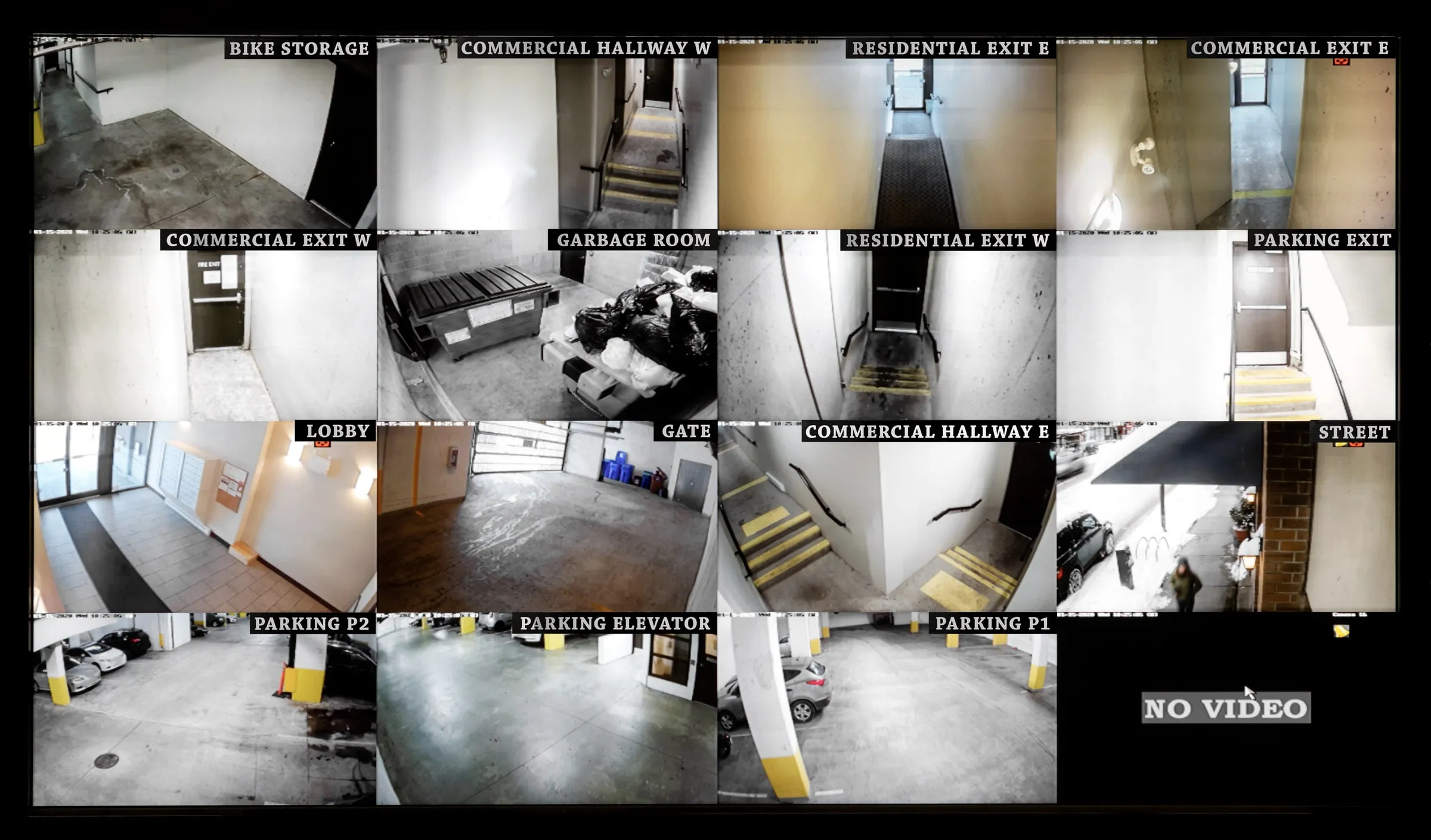 Security monitor wall showing labeled camera feeds of a building's lobby, exits, parking and gate