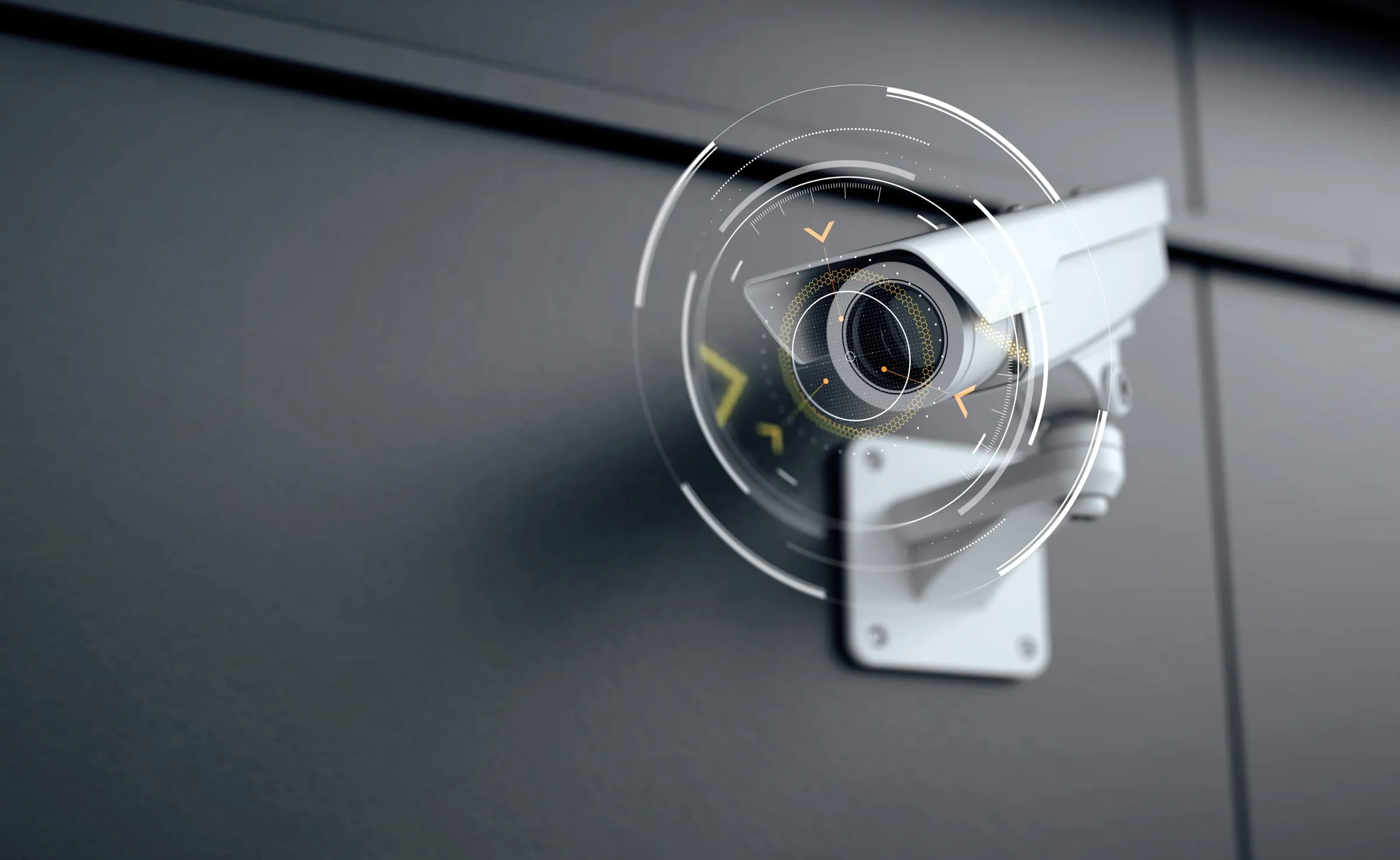 White exterior security camera mounted on a dark wall, shown with a digital targeting overlay graphic